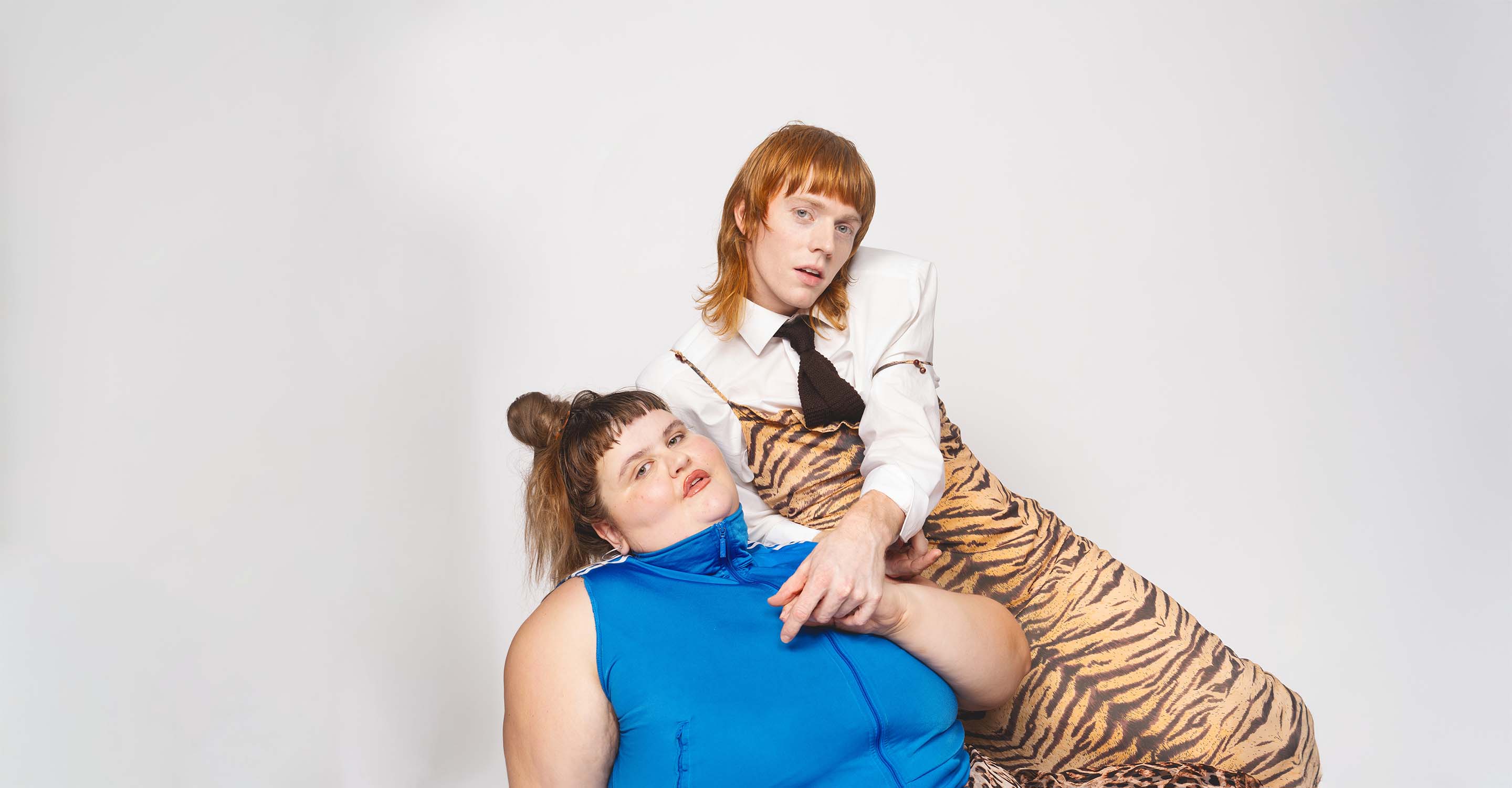 Two persons dressed in clothes with animal patterns